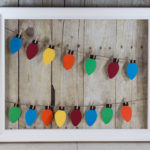 Learn how to make your own paper Christmas lights hanging display!