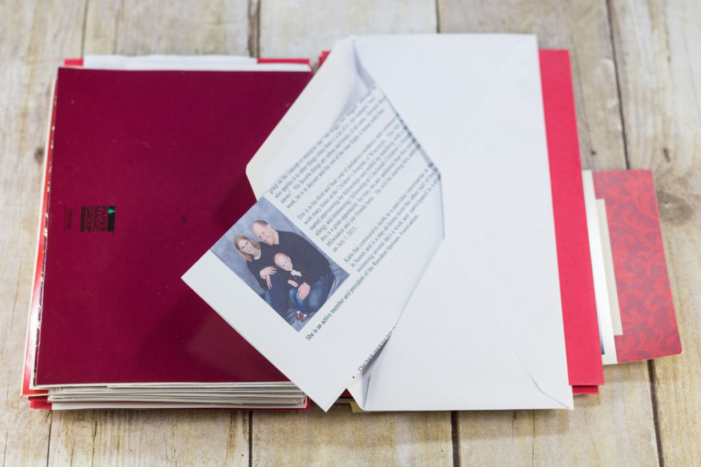 DIY Upcycled Christmas Card Books - I glue an envelope to red cardstock for each double-sided letter.