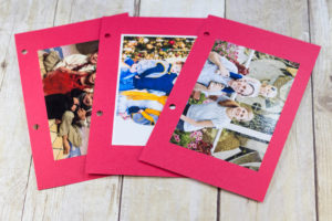 DIY Upcycled Christmas Card Books - I glue the photos to red cardstock. If there's a message or info on the back of the photos (i.e. kids' ages), you may want to write it on the cardstock. | https://www.roseclearfield.com