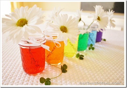 Rainbow Colored Water Mason Jar Centerpiece via Sand and Sisal | https://www.roseclearfield.com