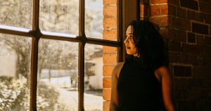 Woman Looking Out the Window