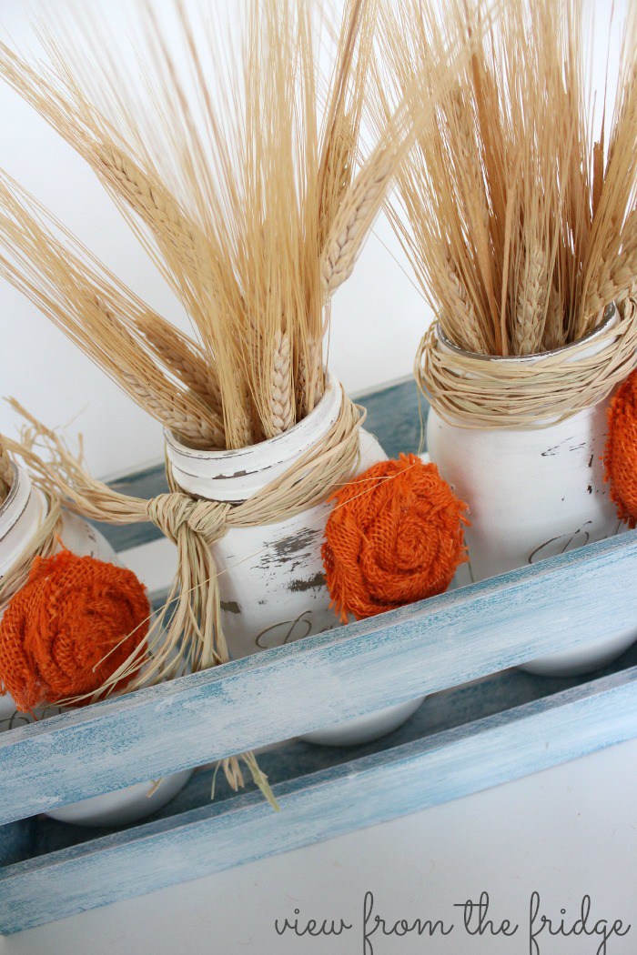 DIY Fall Mason Jar Decor - Fall Mason Jar Centerpiece with Burlap Rosettes via View From the Fridge via Oh My Creative | https://www.roseclearfield.com