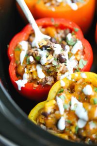 30 Days of Healthy Slow Cooker Dinner Recipes - Slow Cooker Stuffed Peppers via Damn Delicious | https://www.roseclearfield.com
