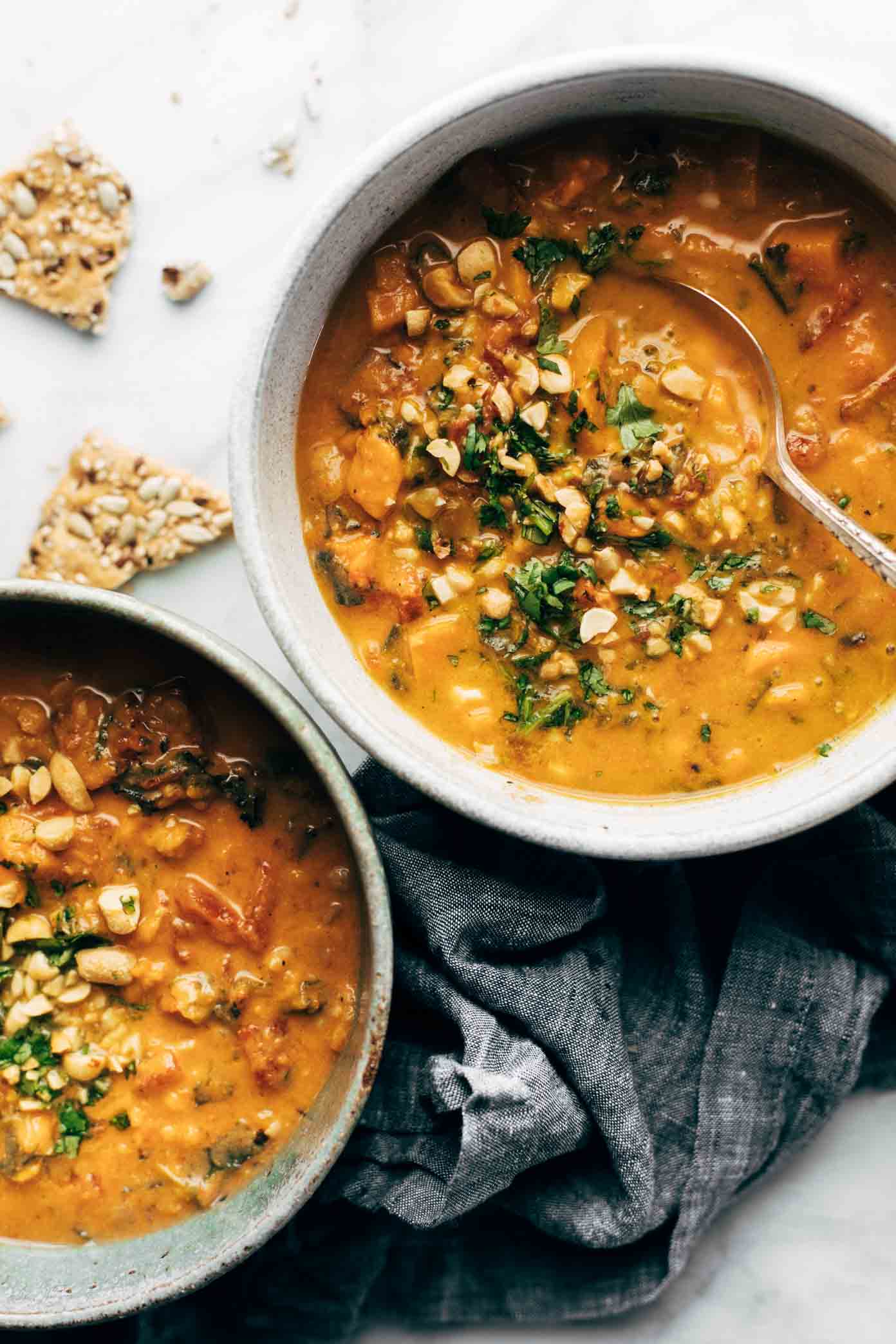 30 Days of Healthy Slow Cooker Dinner Recipes - Spicy Peanut Soup with Sweet Potato and Kale via PInch of Yum | https://www.roseclearfield.com