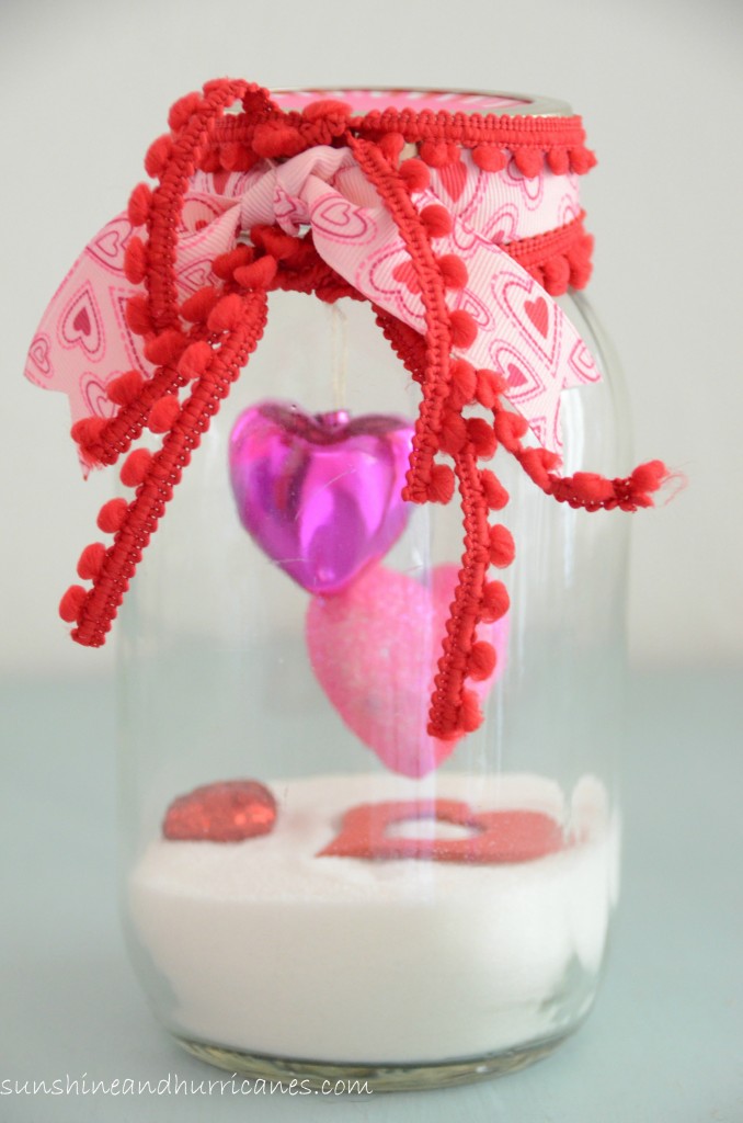 DIY Valentine's Day Mason Jars - Snow Filled Ribbon Tied Valentine's Day Mason Jars via Sunshine and Hurricanes | https://www.roseclearfield.com