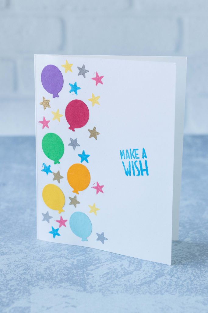 Handmade birthday card featuring rainbow balloons and a mix of rainbow stamped and metallic heat embossed stars, complete with a stamped birthday greeting. #DIY #heatembossed #birthdaycard | https://www.roseclearfield.com