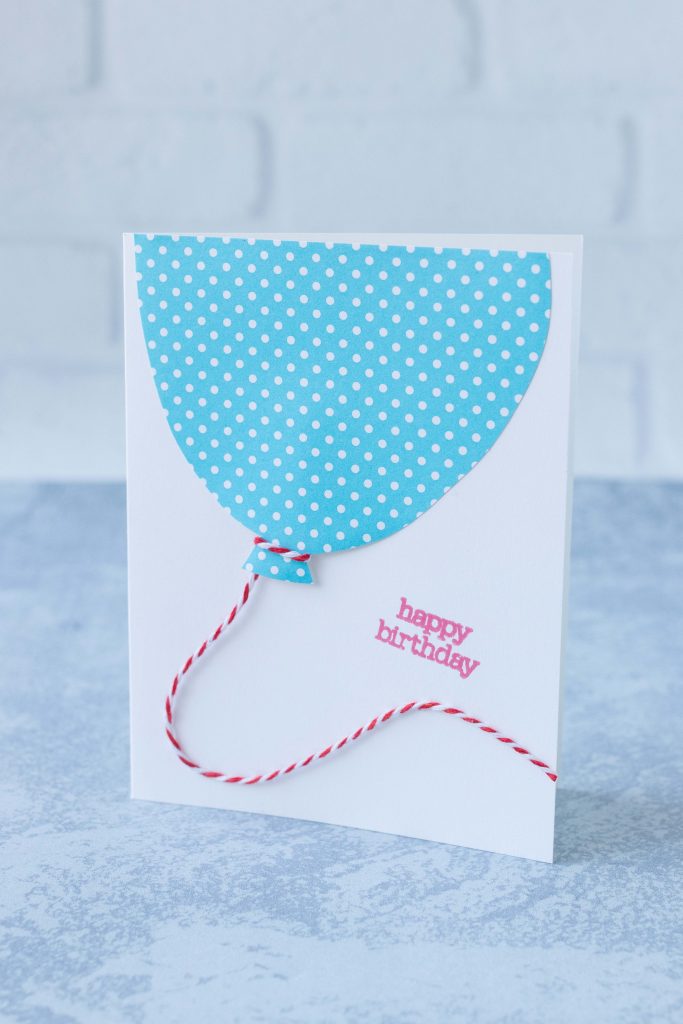 Easy DIY birthday card design featuring a large polka dot balloon tied with a baker's twine string, completed with a stamped birthday greeting. #birthdaycardidea #ballooncard #birthdayballoon | https://www.roseclearfield.com