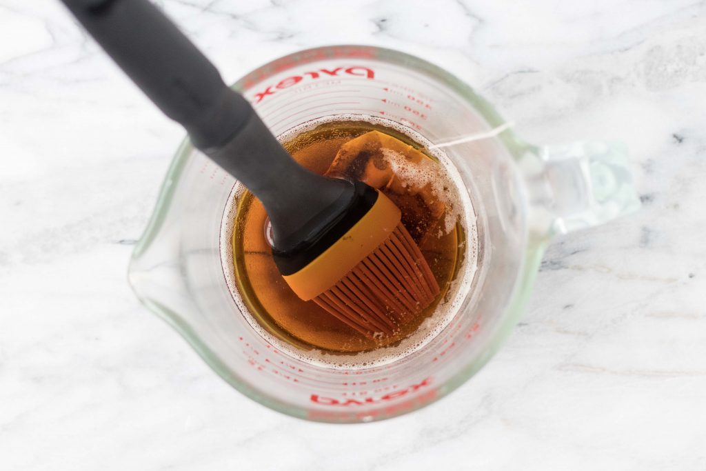 Getting ready to make new paper look antique or vintage. Brush tea on paper with a pastry or basting brush.