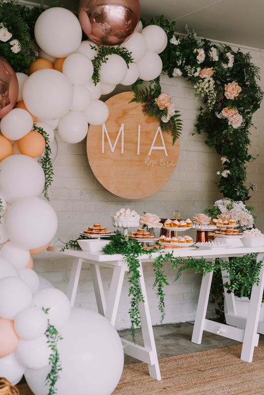 Gorgeous balloon and floral arch over a food display, perfect for a baby shower. #floral #babyshower #balloonarch | https://www.roseclearfield.com