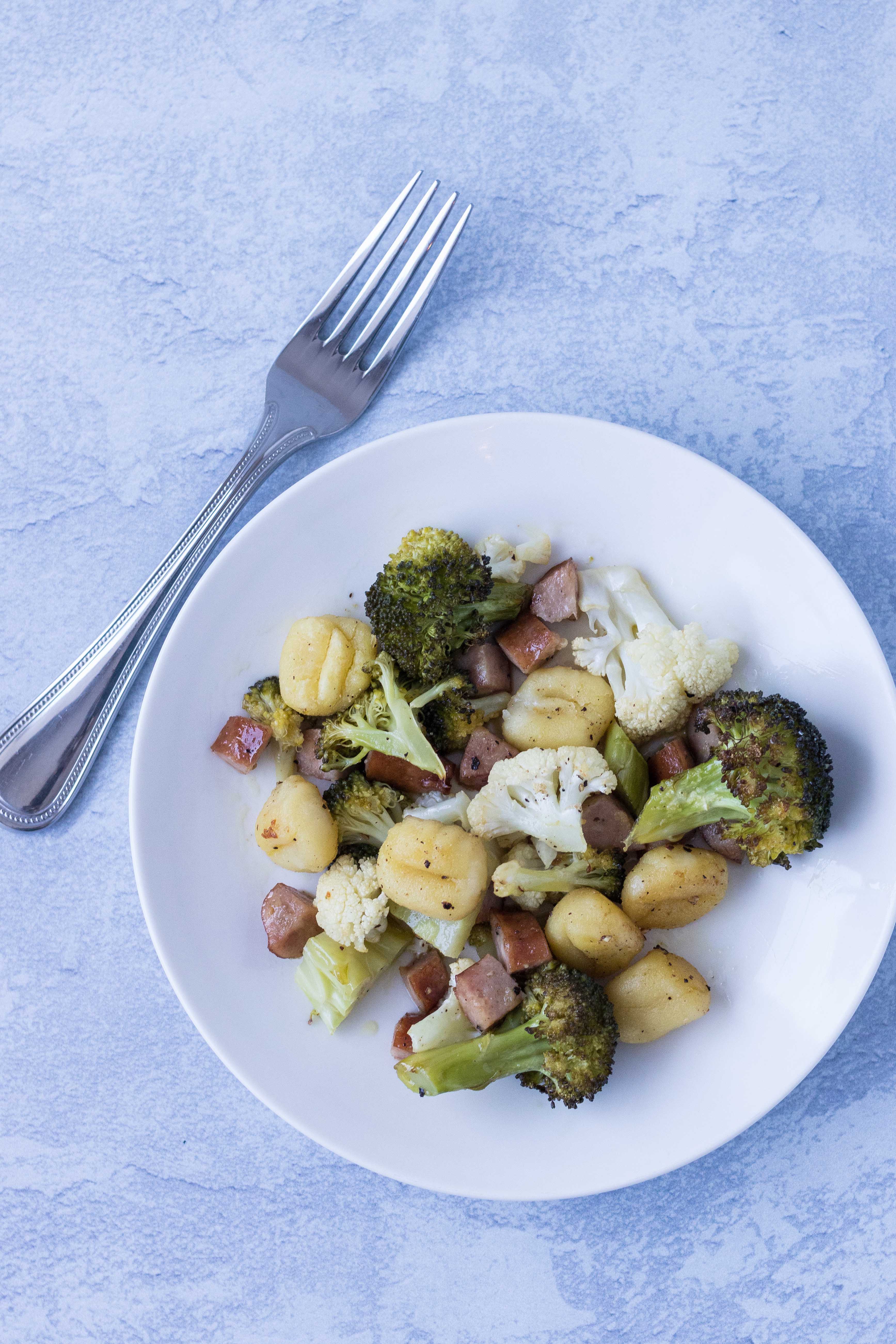 Sheet pan gnocchi with chicken sausage and vegetables is quick and healthy! The perfect weeknight dinner. #healthyeating #weeknightdinner #sheetpanmeal | https://www.roseclearfield.com