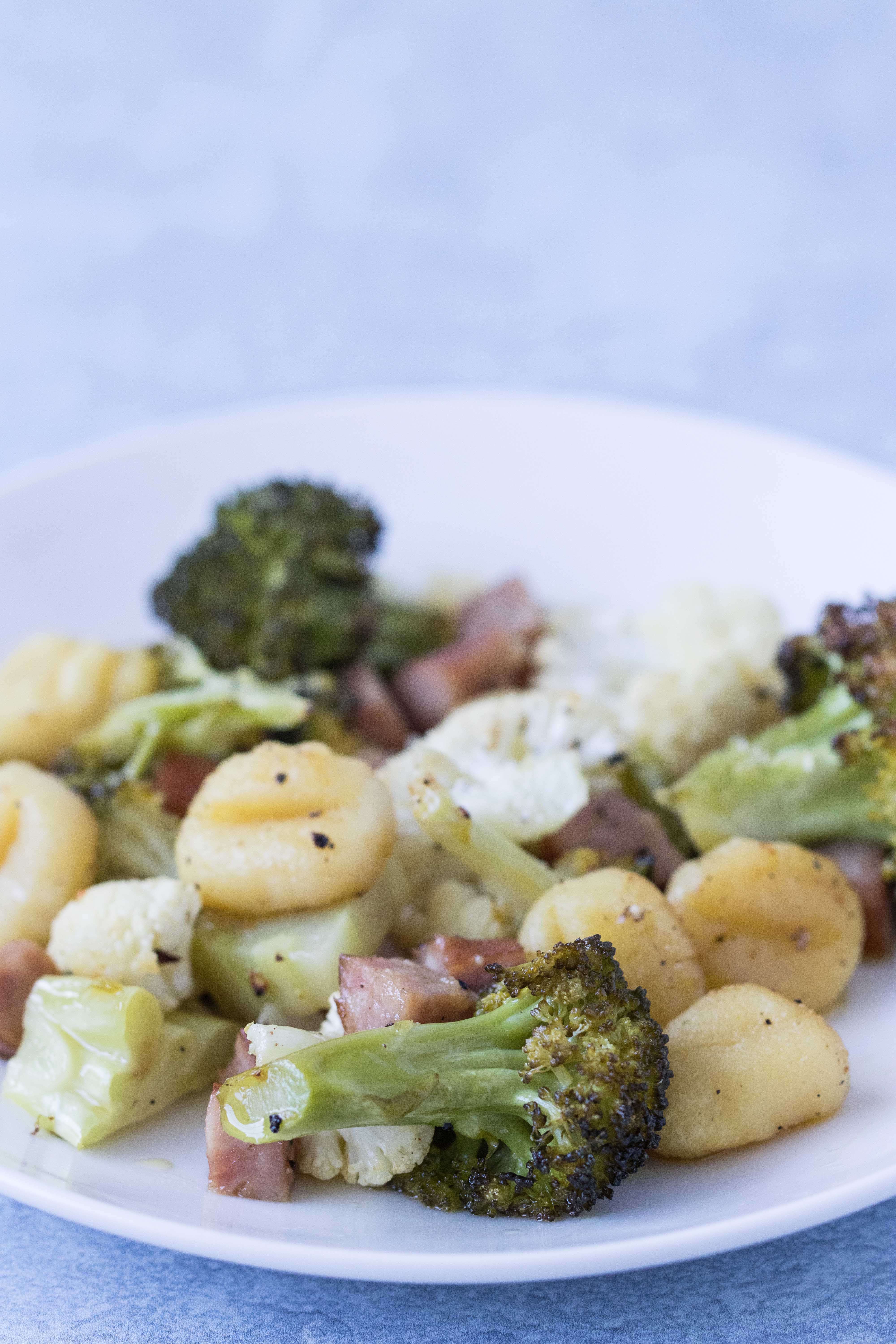 Healthy, family-friendly dinner that comes together in 30 minutes: sheet pan gnocchi with chicken sausage, broccoli, and cauliflower. #healthy #sheetpanmeal #gnocchi | https://www.roseclearfield.com