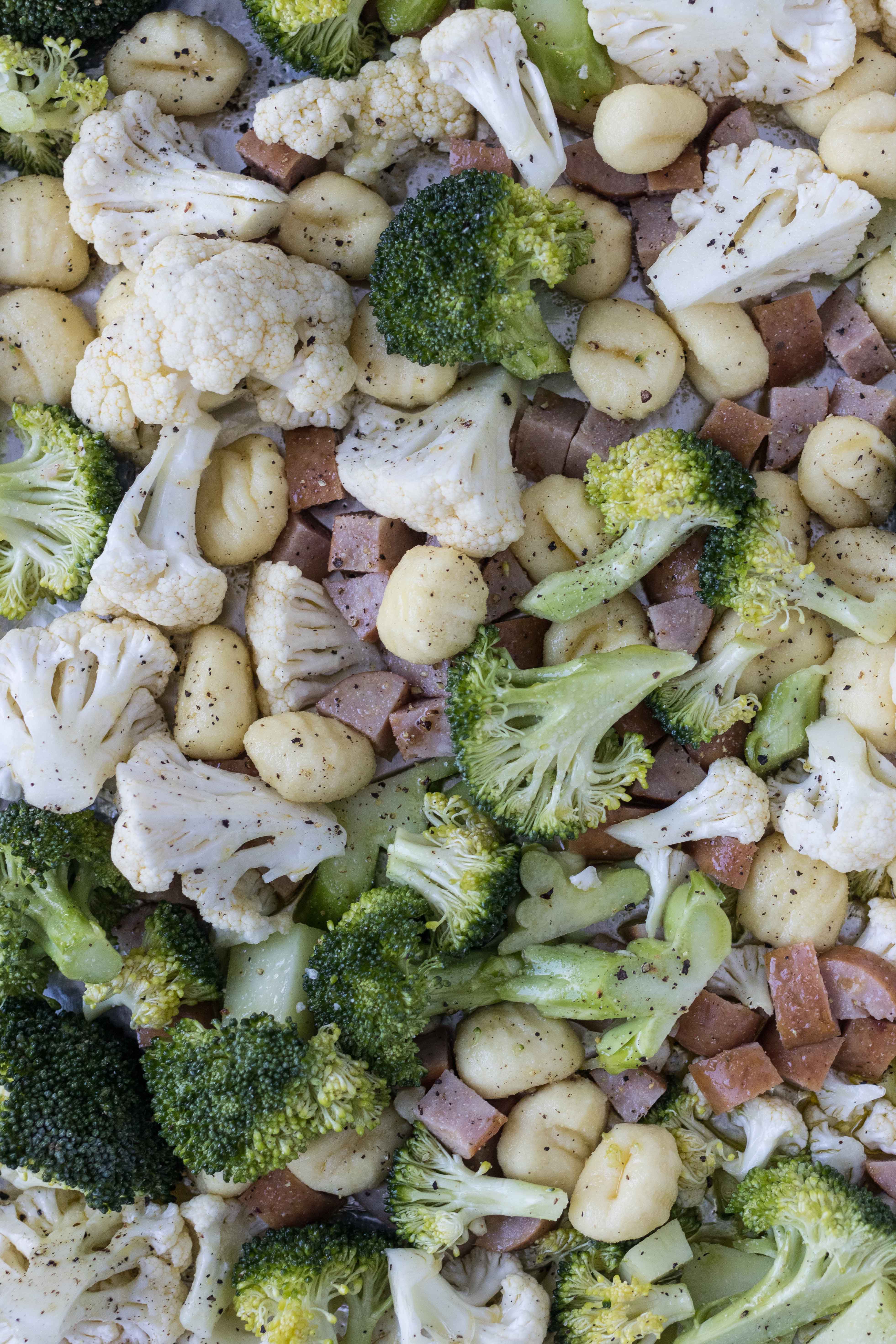 Sheet pan gnocchi with chicken sausage and veggies, ready for the oven! #healthydinner #quickdinneridea #sheetpanmeal | https://www.roseclearfield.com