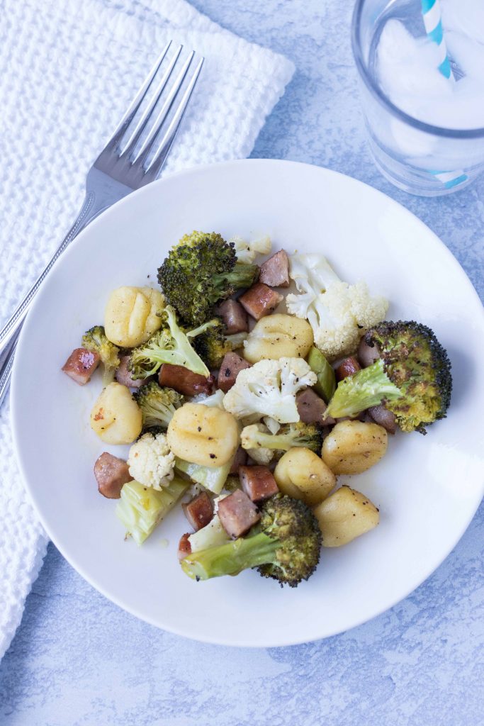 Get dinner on the table in 30 minutes with sheet pan gnocchi with chicken sausage and vegetables! #familyfriendly #healthyeating #sheetpanmeal | https://www.roseclearfield.com