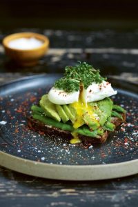 Avocado toast topped with asparagus and poached egg, via Tasting Table. Delicious and healthy! #avocadotoast #healthybreakfast #breakfastideas | https://www.roseclearfield.com