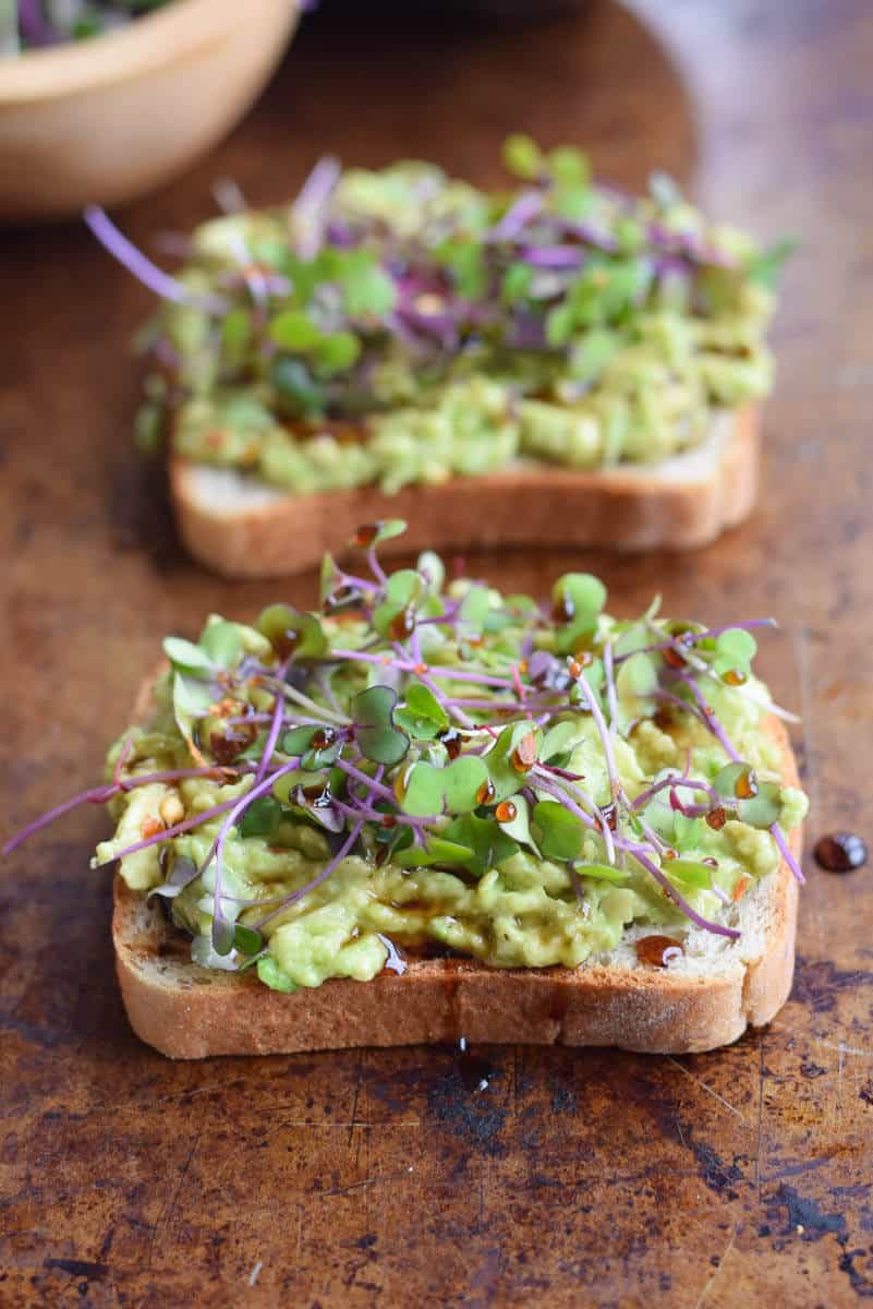 Avocado toast topped with microgreens. Delicious spring breakfast or lunch! via Seasonal Cravings #avocadotoast #healthyeating #healthybreakfast | https://www.roseclearfield.com