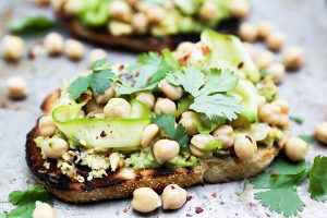 Avocado toast topped with spicy marinated chickpeas and zucchini. Perfect way to use up zucchini! via Floating Kitchen #healthyeating #avocadotoast #zucchinirecipe | https://www.roseclearfield.com