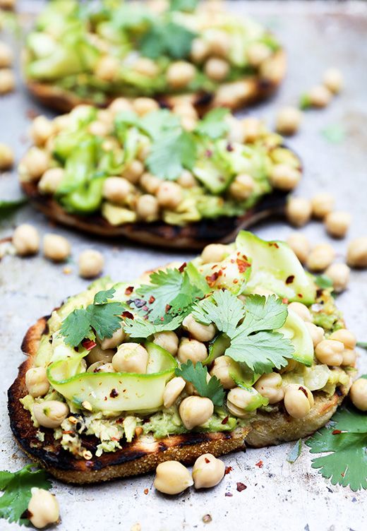 Avocado toast topped with spicy marinated chickpeas and zucchini. Perfect way to use up zucchini! via Floating Kitchen #healthyeating #avocadotoast #zucchinirecipe | https://www.roseclearfield.com