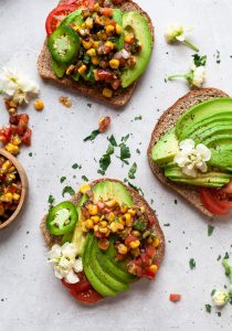 Avocado toast topped with zesty charred corn salsa. Delicious, healthy summer breakfast! via Joyful Healthy Eats #avocadotoast #cornsalsa #breakfastideas | https://www.roseclearfield.com