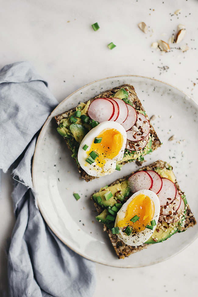 Avocado and egg sandwich with super seed bread. So healthy and flavorful! via The Awesome Green | https://www.roseclearfield.com