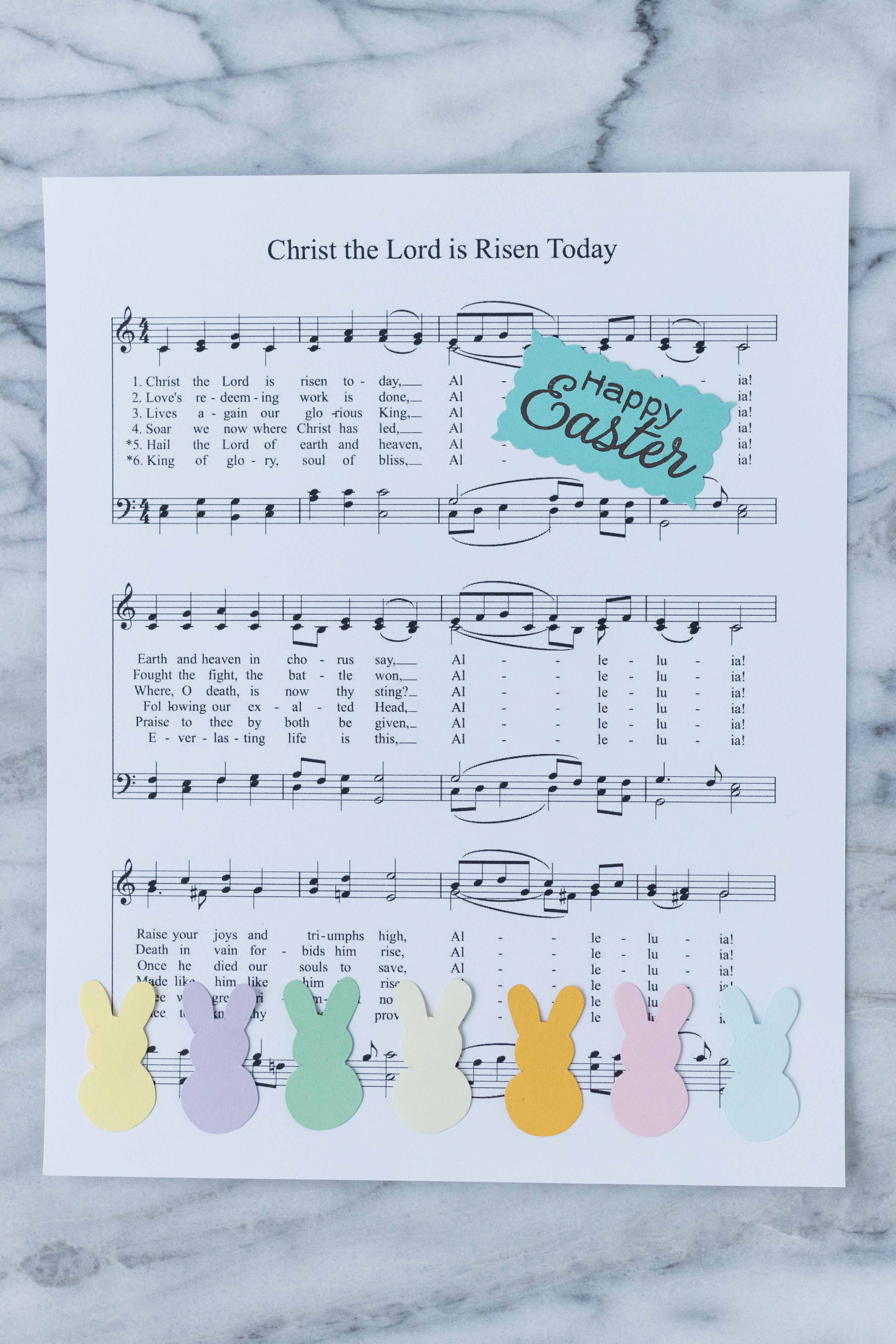 Putting together "Christ the Lord is Risen Today" Easter sheet music decor with pastel bunnies. #Easter #DIY #pastel | https://www.roseclearfield.com