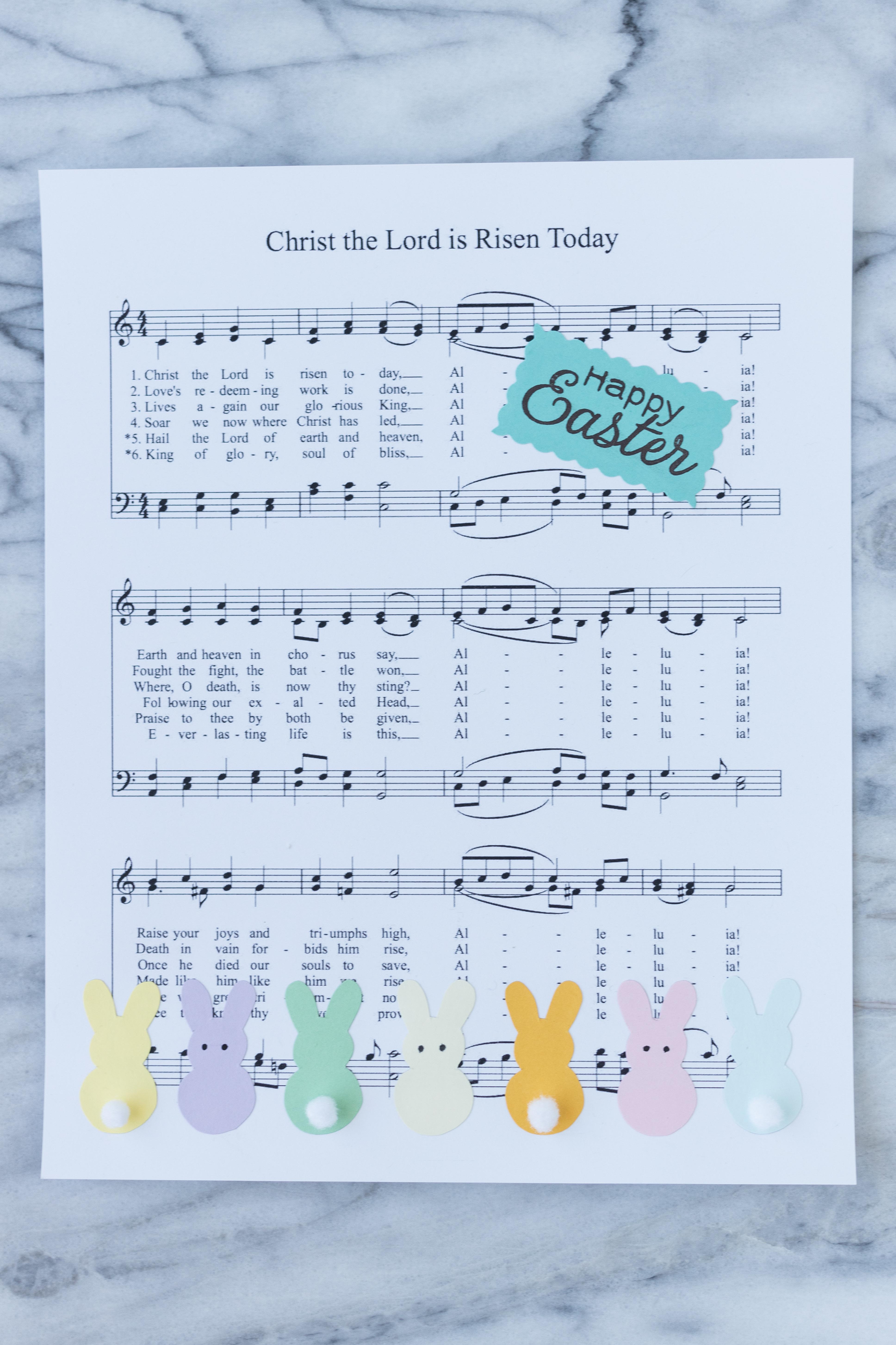 DIY Easter sheet music wall decor in progress! Pom pom tails and eyes add a fun touch to the bunnies. #Easter #DIY #sheetmusic | https://www.roseclearfield.com