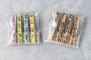 Homemade sheet music clothespin magnets, ready for gift giving with custom music cards and treat bags. #giftidea #musicteachergift #sheetmusiccraft | https://www.roseclearfield.com