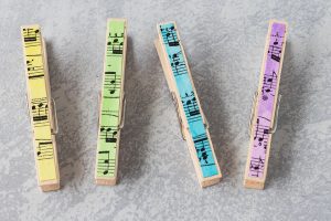 Watercolor painted sheet music for DIY clothespin magnets. So simple and pretty! #DIY #watercolors #clothespins #clothespinmagnets | https://www.roseclearfield.com