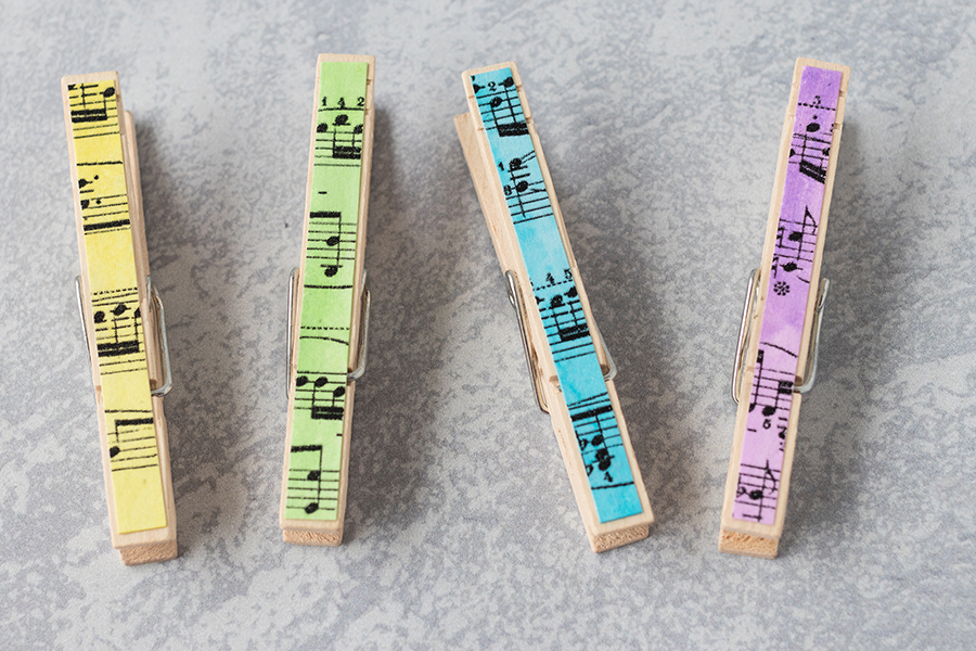 Watercolor painted sheet music for DIY clothespin magnets. So simple and pretty! #DIY #watercolors #clothespins #clothespinmagnets | https://www.roseclearfield.com