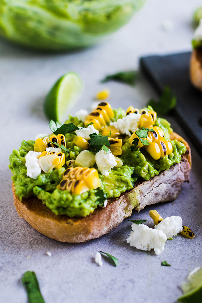 Avocado toast topped with grilled corn, goat cheese, and cilantro. Refreshing, healthy summer breakfast or lunch! via Life as a Strawberry #avocadotoast #grilledcorn #healthybreakfast | https://www.roseclearfield.com