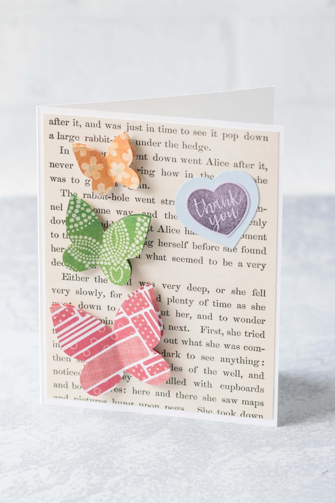 Thank you card with Alice in Wonderland book page background and scrapbook paper butterflies. #thankyoucard #greetingcard #AliceinWonderland #butterflies