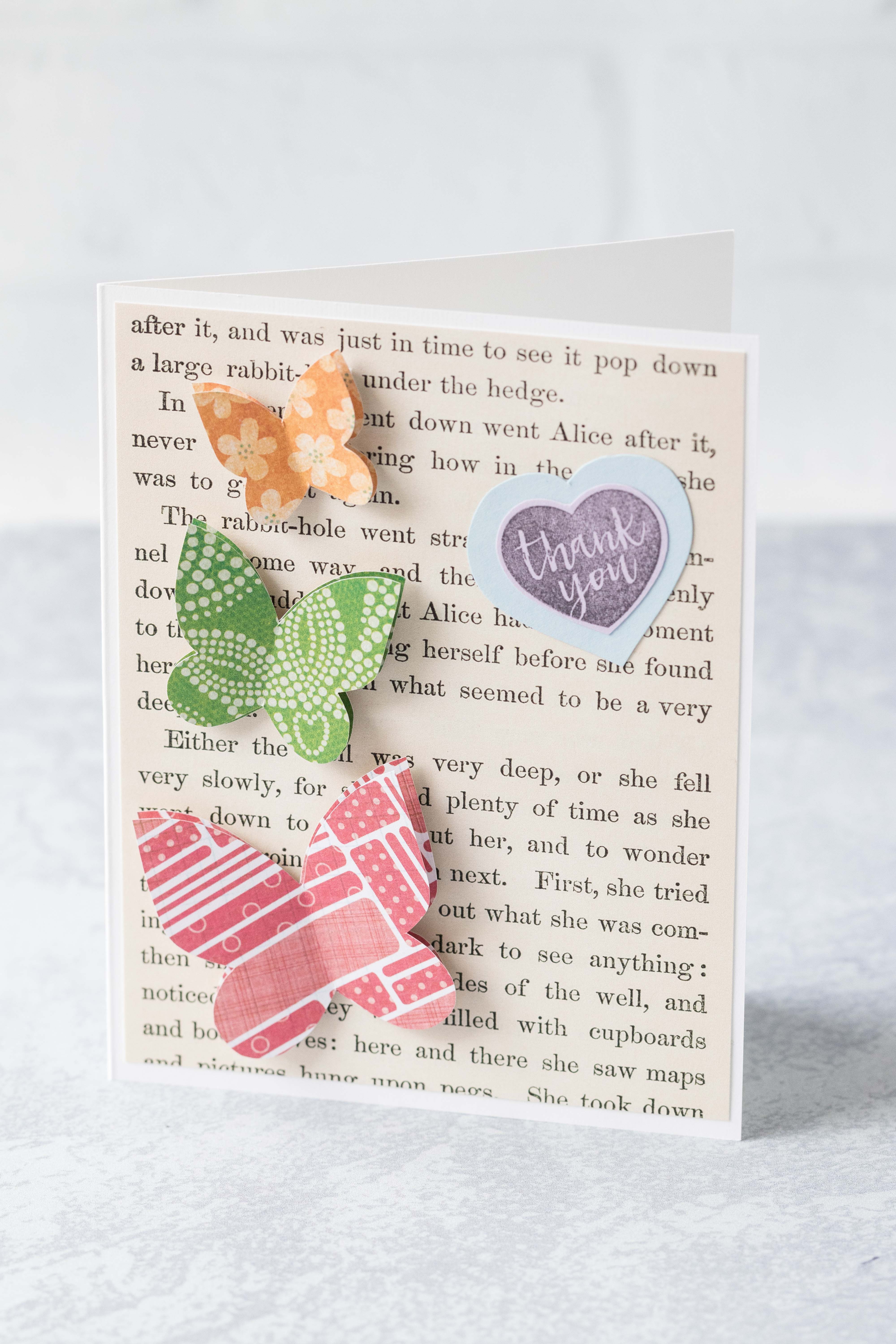 Thank you card with Alice in Wonderland book page background and scrapbook paper butterflies. #thankyoucard #greetingcard #AliceinWonderland #butterflies | https://www.roseclearfield.com