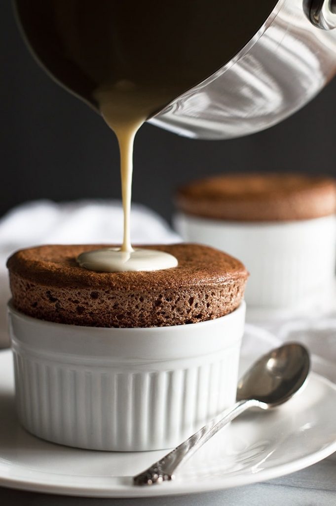 Chocolate souffles for two, topped with creme anglaise for a truly decadent touch. via Baking Mischief #chocolatesouffle #cremeanglaise #dessertfortwo | https://www.roseclearfield.com