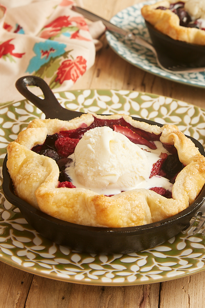 Mini skillet mixed berry pies for two. Delicious mixed berry dessert, perfectly portioned for two! #mixedberrypie #skilletpie #dessertfortwo | https://www.roseclearfield.com