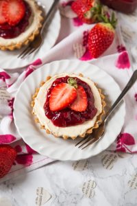 No-bake strawberry cheesecakes for two. Simple, delicious date night recipe! via Annie's Noms #nobake #strawberrycheesecake #dessertfortwo | https://www.roseclearfield.com