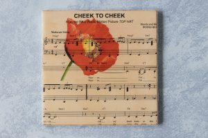 Custom DIY tile coaster with Cheek to Cheek and a vintage poppy image. #DIY #tilecoaster #sheetmusiccraft | https://www.roseclearfield.com