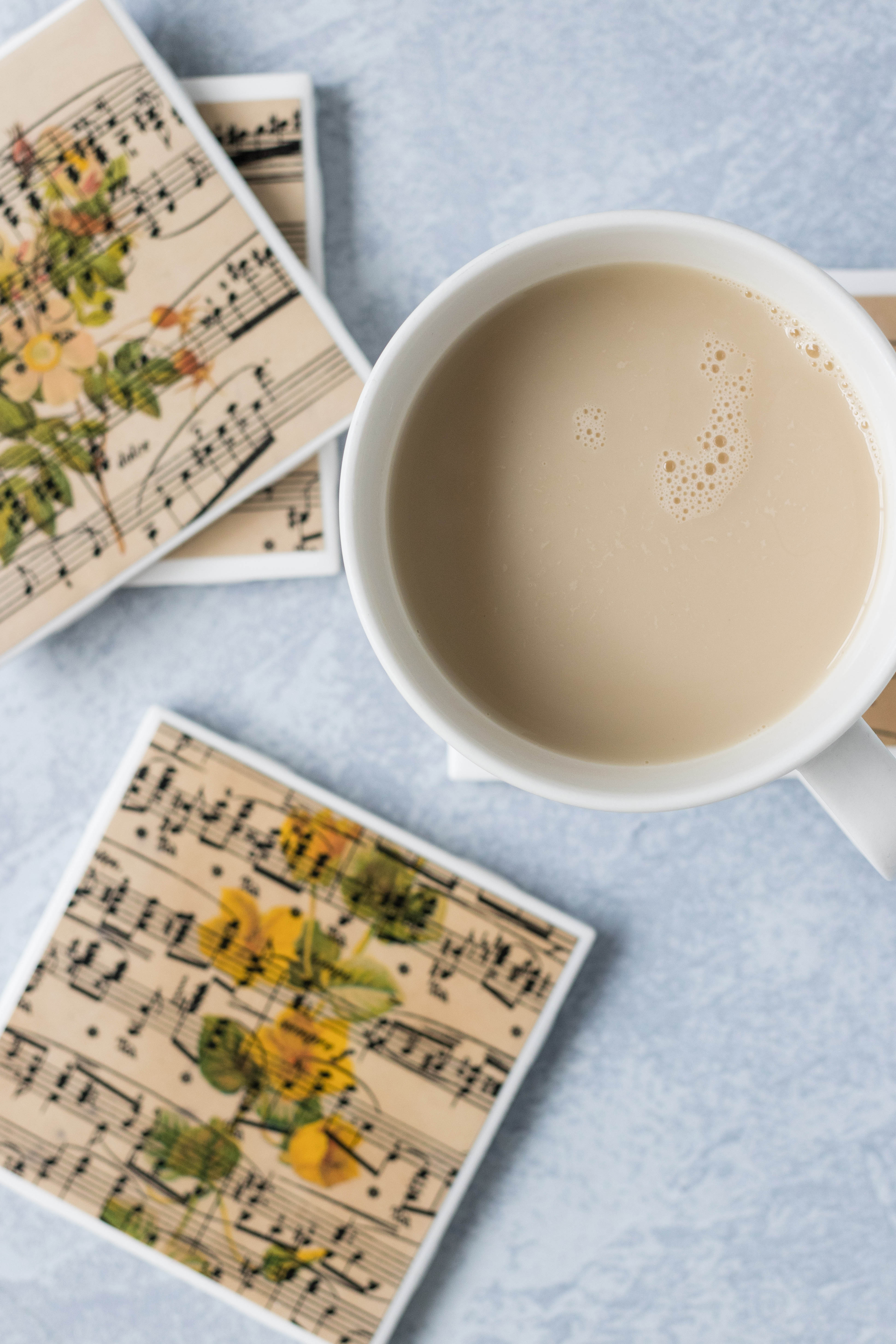 DIY antique sheet music tile coasters with vintage botanicals. Fun DIY home decor project! #DIY #vintagesheetmusic #sheetmusiccraft #homedecor | https://www.roseclearfield.com