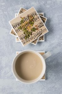 DIY vintage sheet music floral tile coasters. Perfect home decor project for anyone who loves sheet music crafts! #sheetmusic #tilecoasters #DIYhomedecor