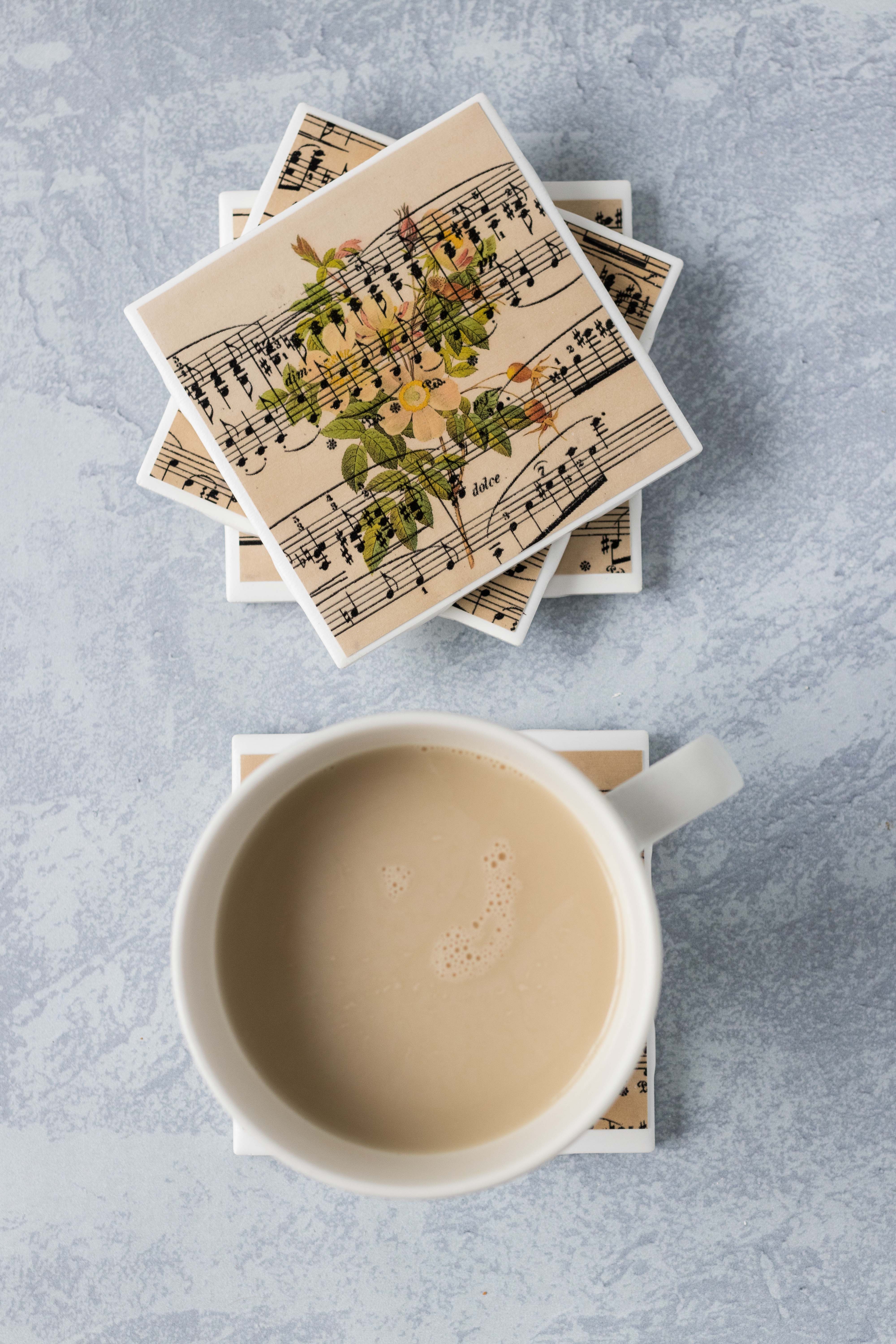 DIY vintage sheet music floral tile coasters. Perfect home decor project for anyone who loves sheet music crafts! #sheetmusic #tilecoasters #DIYhomedecor | https://www.roseclearfield.com