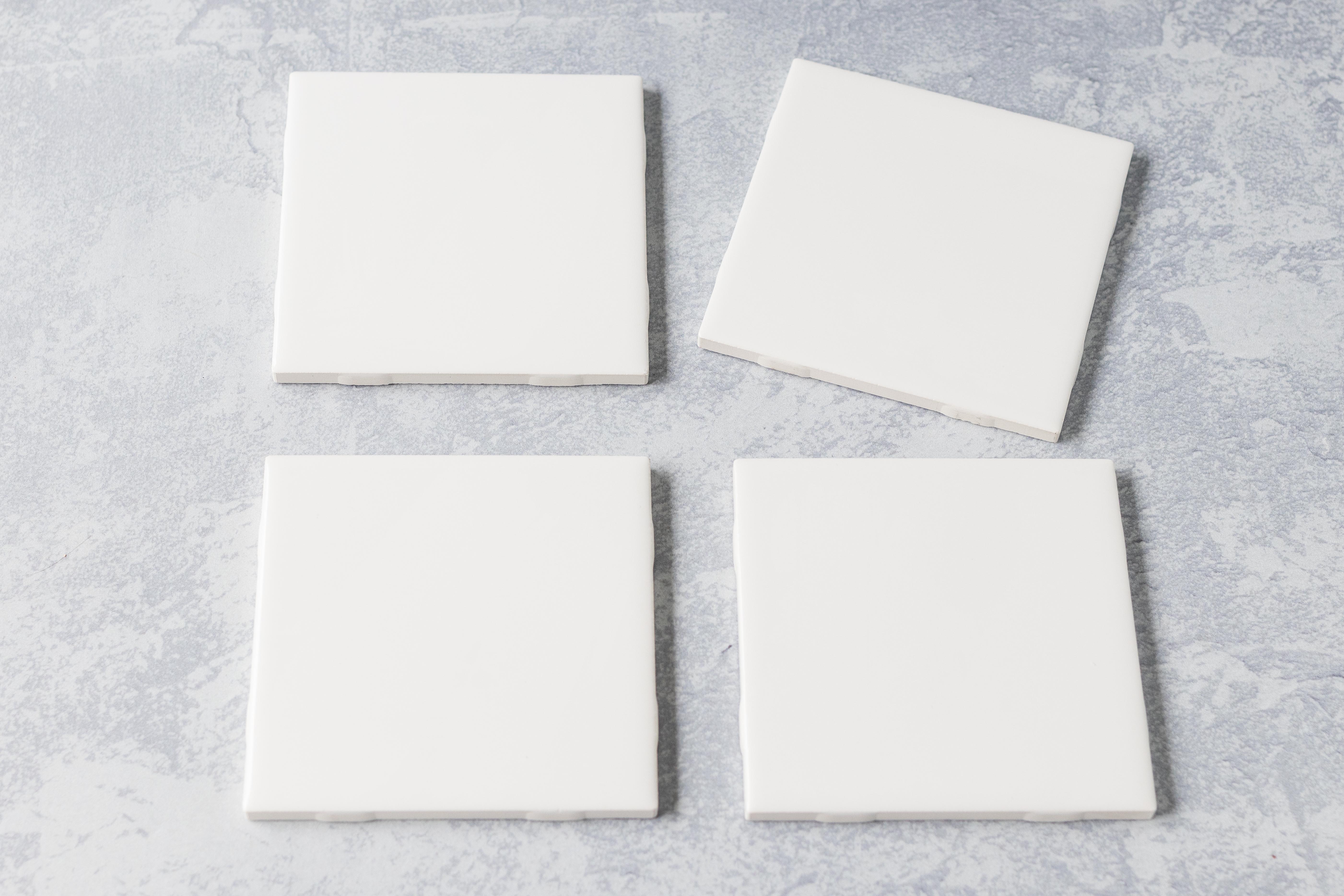 Plain white ceramic tiles from the hardware store, ready to be transformed into homemade coasters. #DIY #ceramictiles #handmadecoasters | https://www.roseclearfield.com