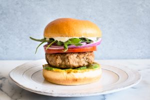 Mediterranean turkey burger with cucumber, tomato, red onion, arugula, and whipped feta. Packed with flavor! via Kitchen Konfidence | https://www.roseclearfield.com