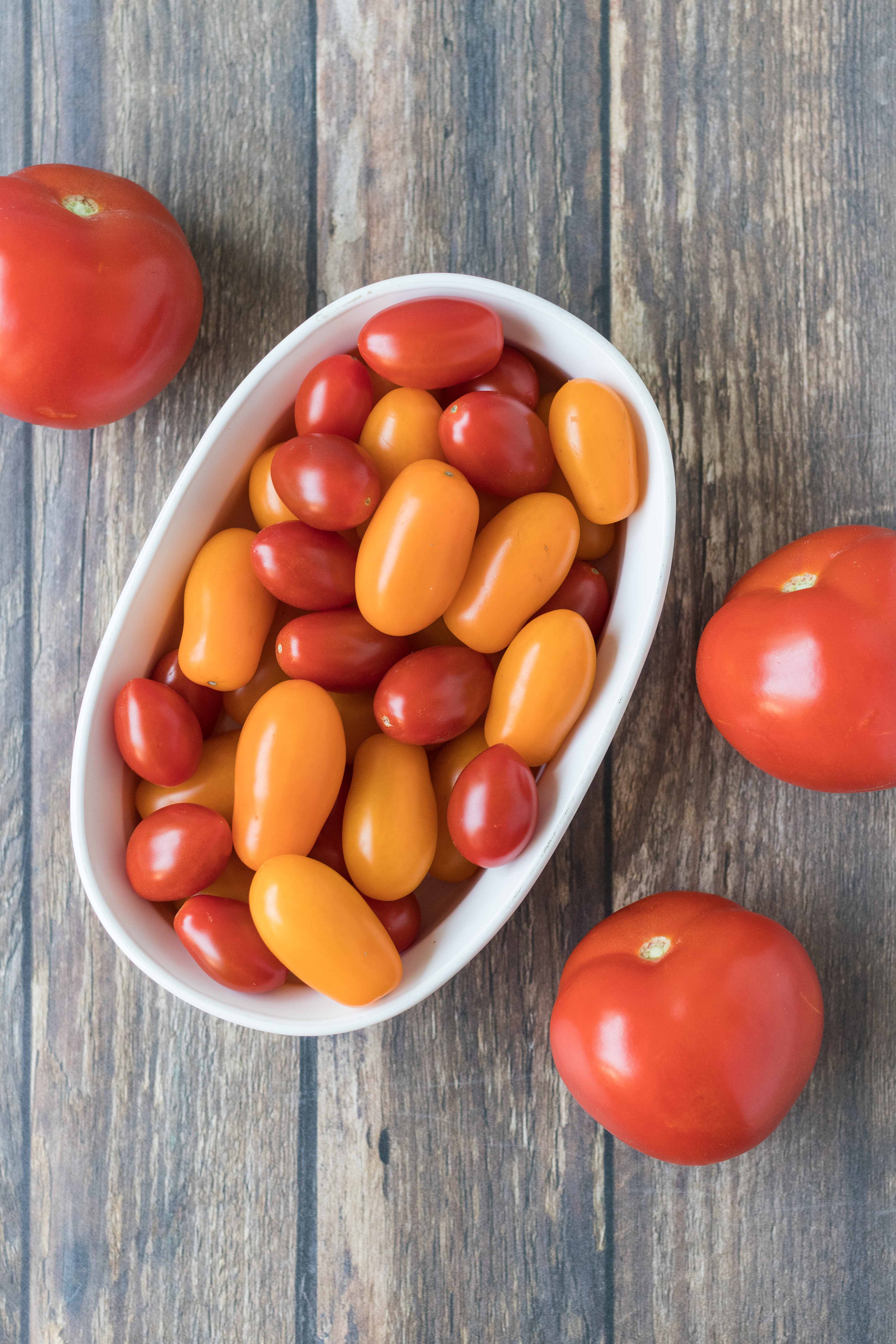 Full-size tomatoes and both red and yellow cherry tomatoes are great options are caprese salad and other caprese recipes. #capreserecipes #capresesalad #tomatoes | https://www.roseclearfield.com