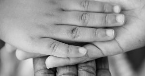 Man, Woman, and Child Holding Hands
