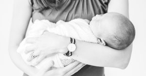 Newborn Baby in Mom's Arms